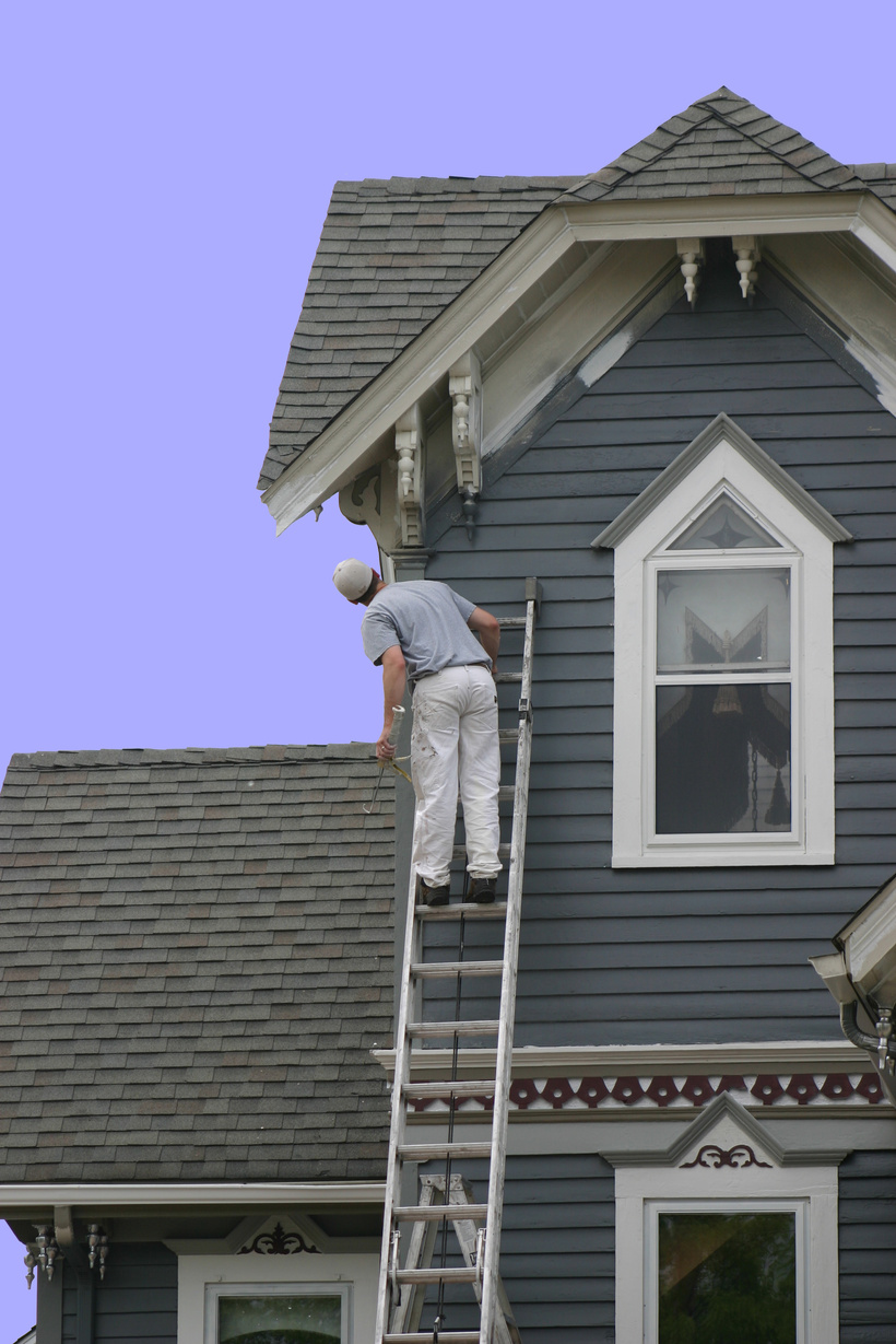 Painter painting the exterior of a house